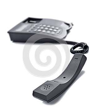 Black telephone on white with space for text