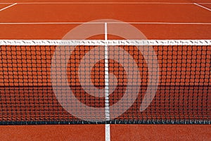 Black tennis net over a red playground