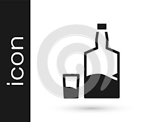 Black Tequila bottle and shot glass icon isolated on white background. Mexican alcohol drink. Vector