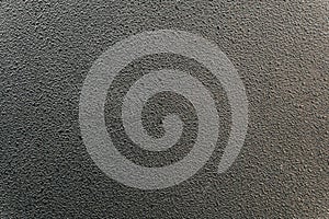 Black textured surface of plastic panel close-up