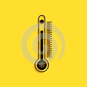 Black Thermometer with scale measuring heat and cold, with sun and snowflake icon isolated on yellow background. Long