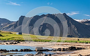 The black Thorgeirsfellshyrna peak seen from the Ytri Tunga beach in the Snaeffelsnes peninsula in western Iceland