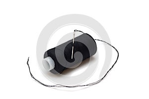 Black thread with a needle and spool of thread