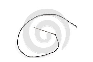 Black thread in a needle on a white background
