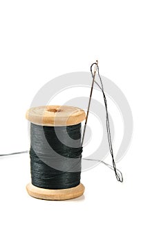 Black thread spool with needle