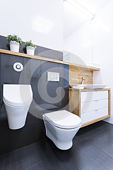 Black tiles in bathroom in apartment