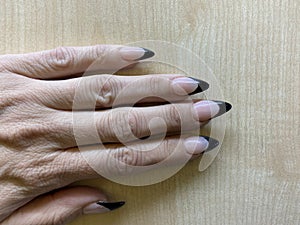 Black tip French manicure with claw points trendy nail design in acrylic applied nail