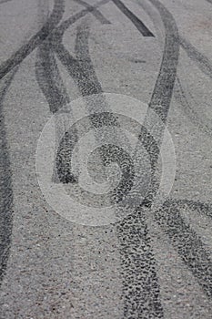 Black tire traces on asphalt.