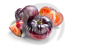 Black tomato, fresh ripe natural bio tomatoes close-up. Tasty organic Black Beauty tomato isolated on white