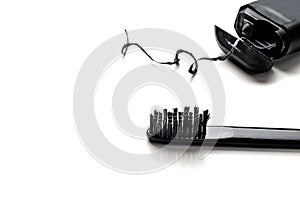 black toothbrush and dental floss isolate on white background