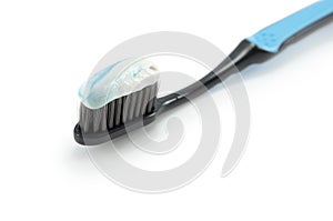 black toothbrush with the minty color of toothpaste