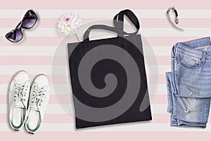 Black tote bag mockup, flat lay on summer style background