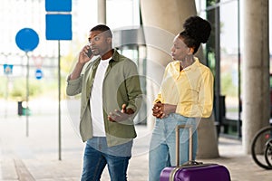 Black Tourists Couple Talking On Phone Having Problem Outside Airport