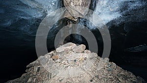 The black transparent color of ice in the cave.