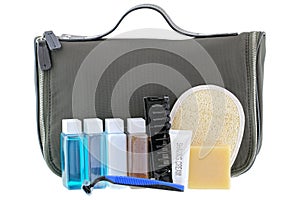 Black traveling cosmetic bag with toiletries, isolated on white