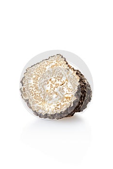 Black truffle half isolated on white
