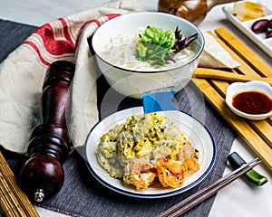 Black Truffle Sea Shrimp Scrambled Egg Fish Udon served in bowl with chopsticks isolated on napkin side view of japanese food on