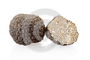 Black truffle and section isolated on white