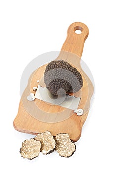Black truffle, slices and wooden truffle slicer