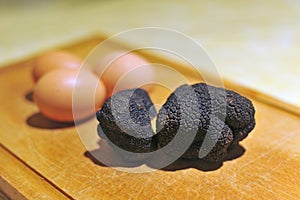 black truffles on a chopping board