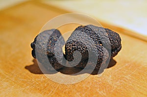 black truffles on a chopping board