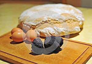 black truffles on a chopping board