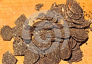 black truffles on a chopping board