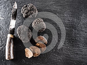 Black truffles on a graphite board.