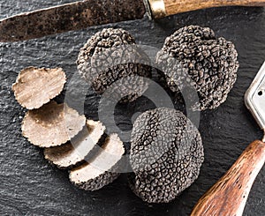 Black truffles on a graphite board.