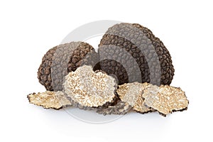 Black truffles group and slices on white