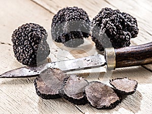 Black truffles on a old wooden table. photo