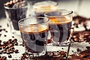 Black Turkish coffee in glass cups and spilled coffee beans