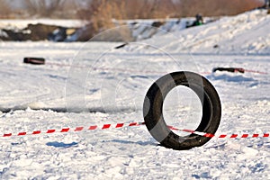 Black tyre on snowy racetrack