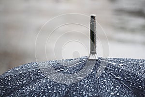 A black umbrella under rain