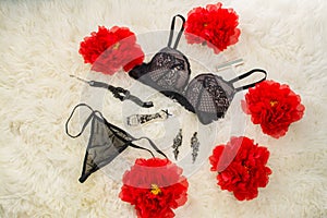 Black underwear knickers and bra in gliter  perfume flowers juwelery  on white background