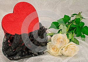 Black underwear knickers in gliter red box heart shaped white roses on white background