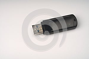 Black usb 3.0 flash drive on a white background closeup.