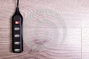 Black USB hub on a wooden background