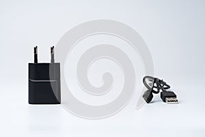 Black USB power adapter and cable for divice isolated on a white background