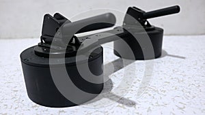 Black vacuum suction cup for removing tiles from floor