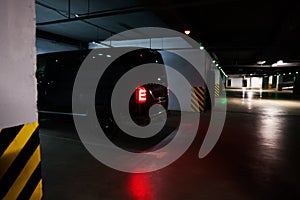 Black van in parking garage at night photo