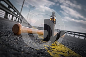 the black vaporizer on a grey pavement