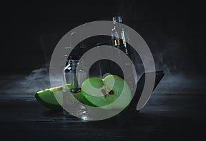 Black vaporizer in the smoke with sliced apple