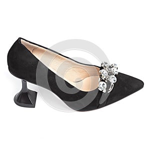 Black velvet women& x27;s heeled shoes with beige insole decorated with crystals on the front on a white background