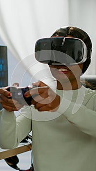 Black videogamer woman winning space shooter game using virtual reality