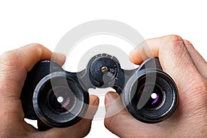 Black vintage binoculars in hands isolated on white