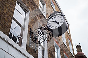 Black vintage clock on Doughty Street Royal Oak, London, UK