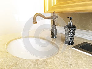 Black vintage water tap and bottle of liquid soap