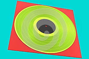 Black vinyl LP record with cover isolated on green background.