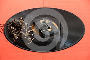 Black vinyl record on colored background and cassetta photo